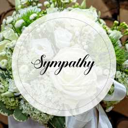 White sympathy bouquet with roses and small white filler flowers