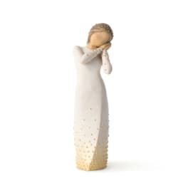 Decorative figurine of a woman in a long white dress with gold accents