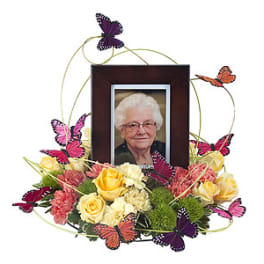 Framed portrait surrounded by roses and butterflies