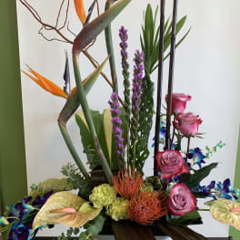 Tall tropical arrangement with pink roses and orange bird-of-paradise flowers