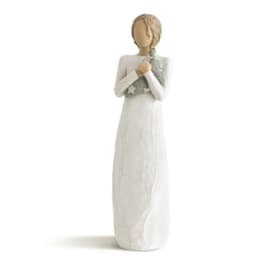 Tall angel figurine in a white dress holding a small star-patterned item