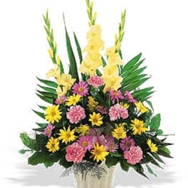 Yellow gladiolus and pink-yellow mixed flowers in a vase