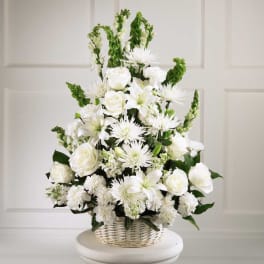 White floral arrangement in a wicker basket