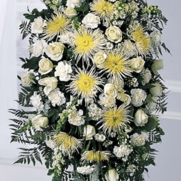 Standing funeral spray with white roses and yellow spider mums