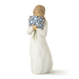 Figurine of a girl holding a bouquet of blue flowers