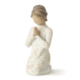 Carved figurine of a kneeling woman with hands clasped