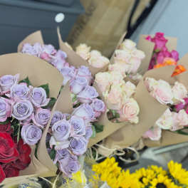Assorted bouquets of roses wrapped in brown paper