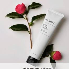 Pink flower sprigs beside a white cleanser tube