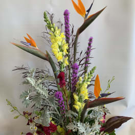 Tall tropical bouquet with orange bird-of-paradise and yellow snapdragons