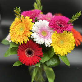 Bright gerbera daisy bouquet in a glass vase