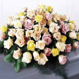 Large bouquet of pastel roses in cream, pink, and yellow