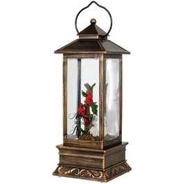 Decorative lantern with a small floral arrangement inside