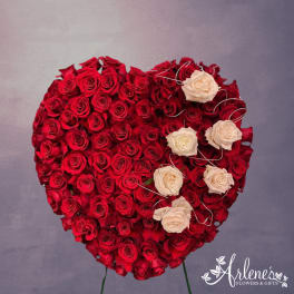 Heart-shaped arrangement of red and white roses