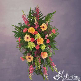 Tall standing spray of peach roses, yellow gerbera daisies and green hydrangea with pink accents