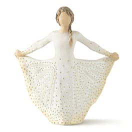 Figurine of a girl in a white dress with gold dots