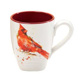 White ceramic mug with a red cardinal illustration and red interior