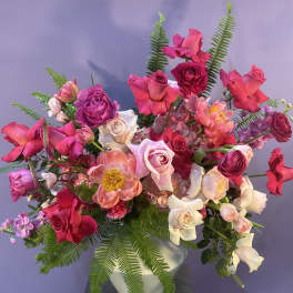 Pink and white mixed flower arrangement in a white vase