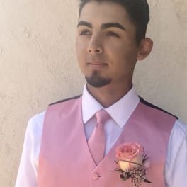Man wearing a pink vest with a pink boutonniere