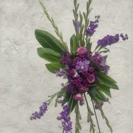 Tall purple floral spray with roses and long stems