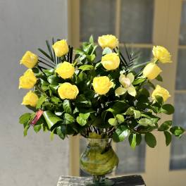 Yellow roses arranged in a clear glass vase