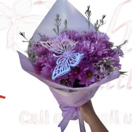 Purple bouquet with butterfly decorations and ribbon wrap