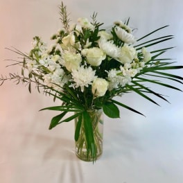 White floral arrangement in a clear glass vase