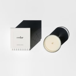 Cedar scented candle in a black-and-white box with the lid off