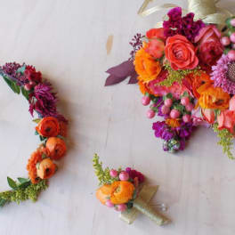 Colorful floral bouquet, wreath, and boutonniere on a light background