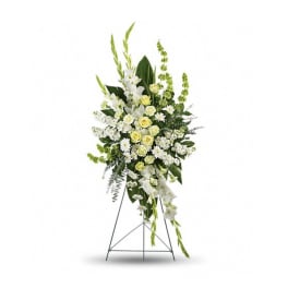 Tall white and pale yellow standing flower spray with roses and mums on a metal easel