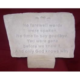 White memorial plaque with an engraved sympathy message on a red background