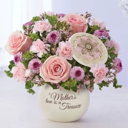 Pink roses and purple flowers in a cream vase with a Mother's Day message