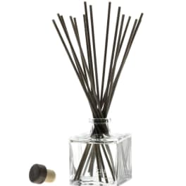 Clear square glass reed diffuser with black reeds and a cap
