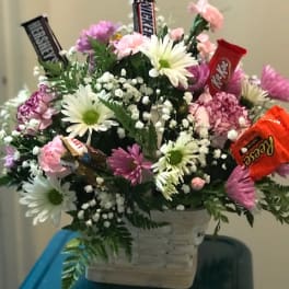 Flower basket with daisies, carnations, and candy bars