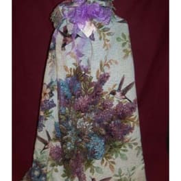 Floral-patterned gift bag with a purple ribbon bow