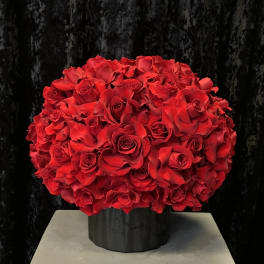Large bouquet of red roses in a black vase