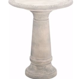 Stone pedestal birdbath with a shallow round basin