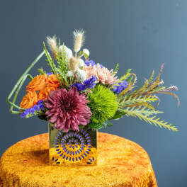 Colorful mixed bouquet in a decorative gold vase
