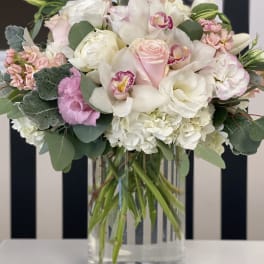 Pink and white bouquet in a clear glass vase