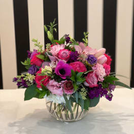 Pink and purple mixed bouquet in a clear glass vase