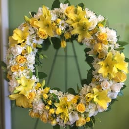Yellow and white floral wreath with roses and lilies