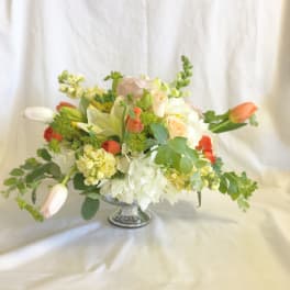 Mixed bouquet in a silver pedestal vase with white and peach flowers