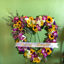 Heart-shaped floral wreath with a "Beloved Daughter" ribbon