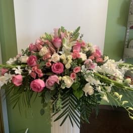 Large pink and white floral arrangement with roses and lilies