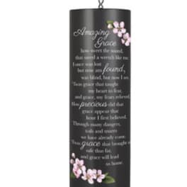 Black hanging wind chime with pink floral accents and printed text