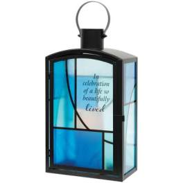 Black lantern with blue glass panels and memorial text
