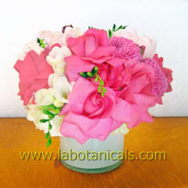 Pink and white flower arrangement in a white vase