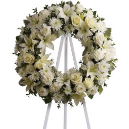 White floral wreath on a standing easel