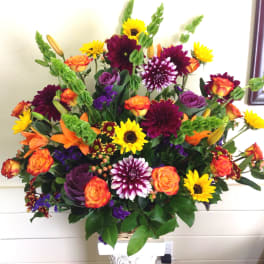Large mixed bouquet with sunflowers, roses, lilies, and purple blooms