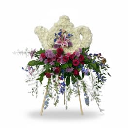 Standing floral spray with white heart-shaped wreath and pink lilies