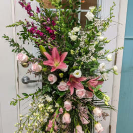 Tall floral standing spray with pink lilies, roses, and white blooms